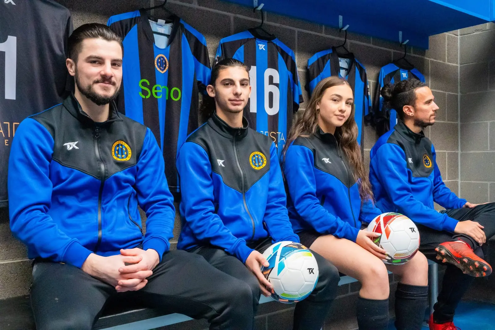 Club players in TX Sports track jackets in the change room